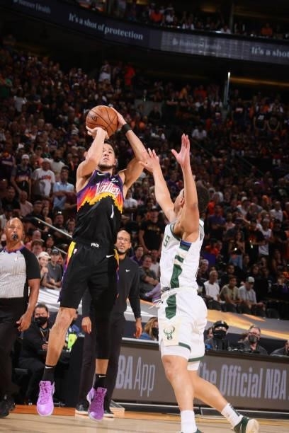 Devin Booker of the Phoenix Suns shoots a three point basket against the Milwaukee Bucks during Game One of the 2021 NBA Finals on July 6, 2021 at...