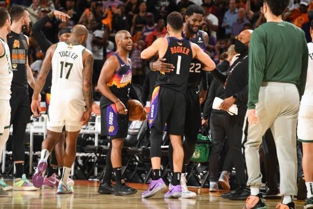 Devin Booker of the Phoenix Suns hugs Deandre Ayton of the Phoenix Suns after the game against the Milwaukee Bucks during Game One of the 2021 NBA...
