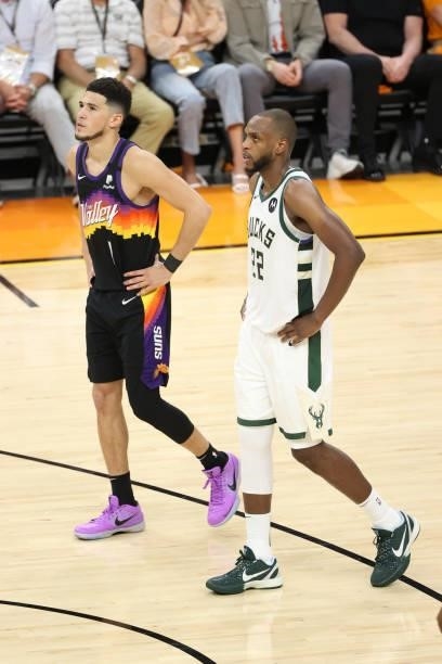 Devin Booker of the Phoenix Suns and Khris Middleton of the Milwaukee Bucks look on during Game One of the 2021 NBA Finals on July 6, 2021 at Phoenix...