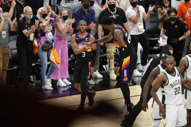 Chris Paul hi-fives Deandre Ayton of the Phoenix Suns during Game One of the 2021 NBA Finals on July 6, 2021 at Phoenix Suns Arena in Phoenix,...