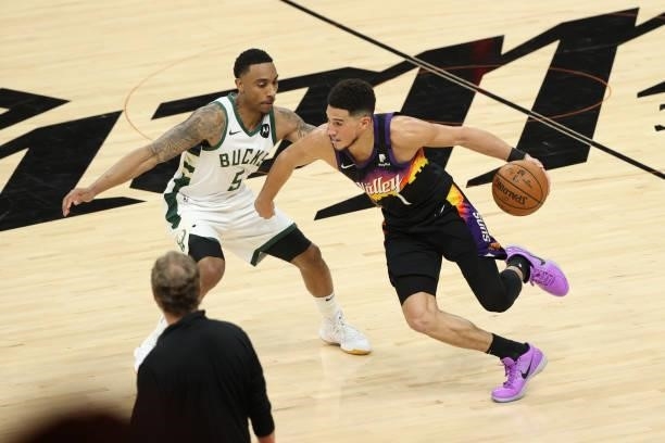 Jeff Teague of the Milwaukee Bucks plays defense on Devin Booker of the Phoenix Suns during Game One of the 2021 NBA Finals on July 6, 2021 at...
