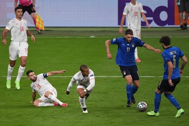 Domenica Berardi of Italy keeps the ball under pressure from Tiago Alcantara of Spain during the UEFA Euro 2020 Championship Semi-final match between...