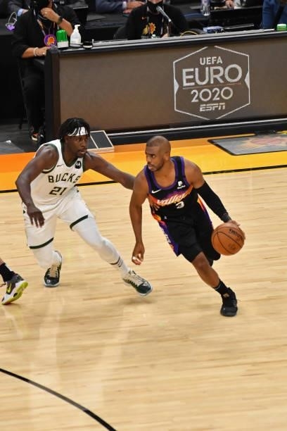 Chris Paul of the Phoenix Suns dribbles the ball around Jrue Holiday of the Milwaukee Bucks during Game One of the 2021 NBA Finals on July 6, 2021 at...