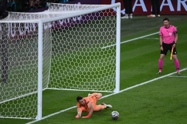 Unai Simon of Spain stops the penalty kick of Manuel Locatelli of Italy in a penalty shootout with Italy during the UEFA Euro 2020 Championship...