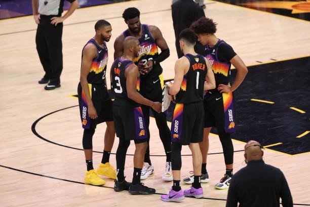 Chris Paul talks with Mikal Bridges, Deandre Ayton, Cameron Johnson and Devin Booker of the Phoenix Suns during Game One of the 2021 NBA Finals on...