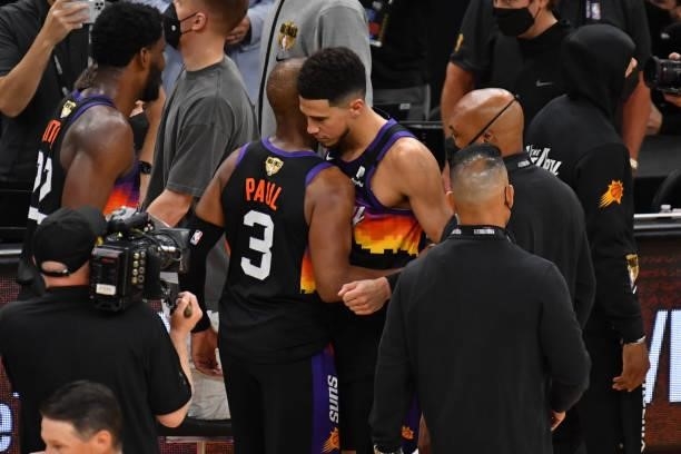 Chris Paul and Devin Booker of the Phoenix Suns hug on court after Game One of the 2021 NBA Finals against the Milwaukee Bucks on July 6, 2021 at...