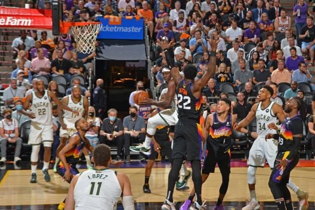 Jrue Holiday of the Milwaukee Bucks drives to the basket and passes the ball against the Phoenix Suns during Game One of the 2021 NBA Finals on July...