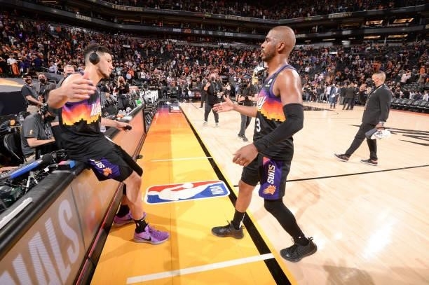 Devin Booker of the Phoenix Suns high fives Chris Paul of the Phoenix Suns after the game against the Milwaukee Bucks during Game One of the 2021 NBA...