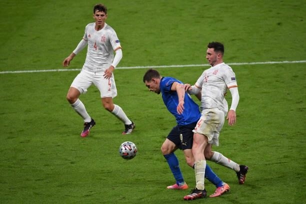 Ayameric Laporte of Spain and Andrea Belotti of Italy compete for the ball during the UEFA Euro 2020 Championship Semi-final match between Italy and...