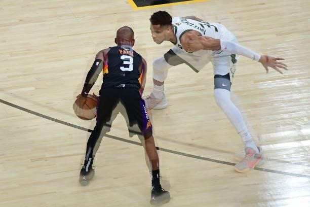 Chris Paul of the Phoenix Suns dribbles the ball while Giannis Antetokounmpo of the Milwaukee Bucks plays defense during Game One of the 2021 NBA...