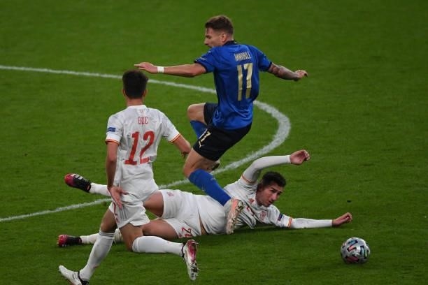 Ciro Immobille of Italy and Aymeric Laporte of Spain compete for the ball during the UEFA Euro 2020 Championship Semi-final match between Italy and...