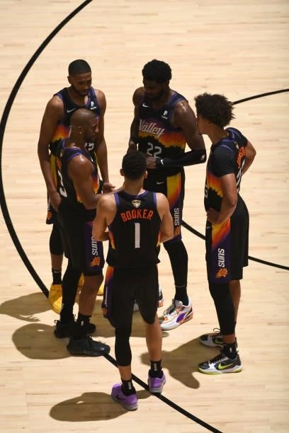 Chris Paul, Devin Booker, Mikal Bridges, Deandre Ayton, and Cameron Johnson of the Phoenix Suns look on during Game One of the 2021 NBA Finals on...