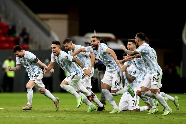Lionel Messi ,Lautaro Martinez and Nicolas Otamendi of Argentina celebrate with teammates winning a Penalty Shootout ,after the Semifinal match...