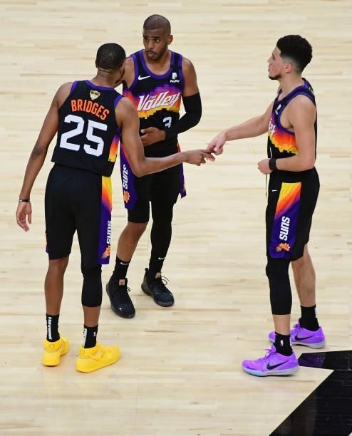 Mikal Bridges, Devin Booker and Chris Paul of the Phoenix Suns talk during Game One of the 2021 NBA Finals against the Milwaukee Bucks on July 6,...