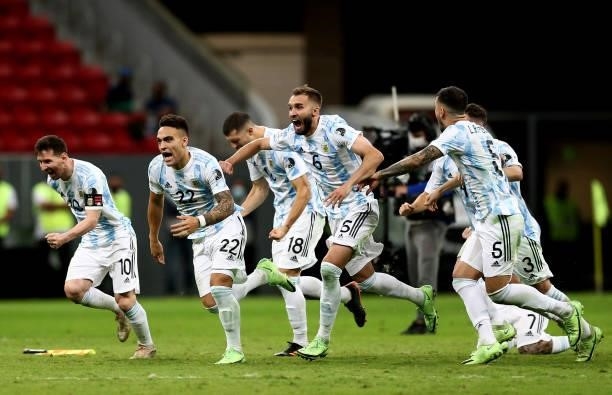 Lionel Messi ,Lautaro Martinez and Nicolas Otamendi of Argentina celebrate with teammates winning a Penalty Shootout ,after the Semifinal match...