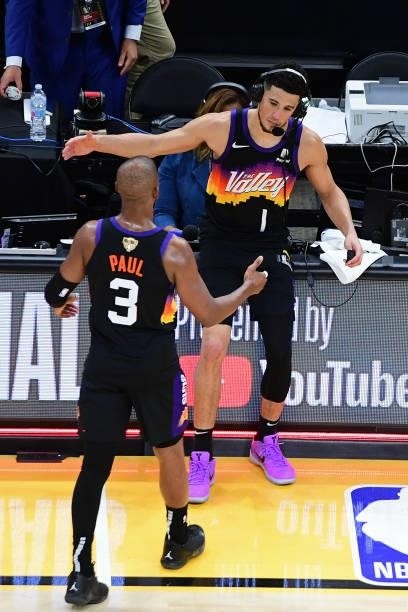 Devin Booker and Chris Paul of the Phoenix Suns shake hands on the court after Game One of the 2021 NBA Finals against the Milwaukee Bucks on July 6,...