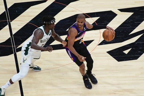 Chris Paul of the Phoenix Suns dribbles the ball while Jrue Holiday of the Milwaukee Bucks plays defense during Game One of the 2021 NBA Finals on...