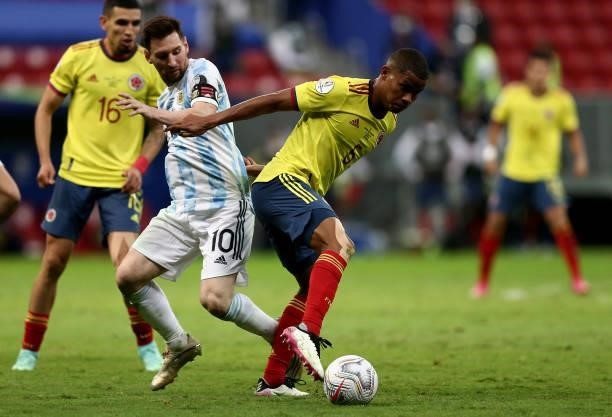 Lionel Messi of Argentina competes for the ball with Wilmar Barrios of Colombia during the Conmebol Copa America Brazil 2021 semi-final between...