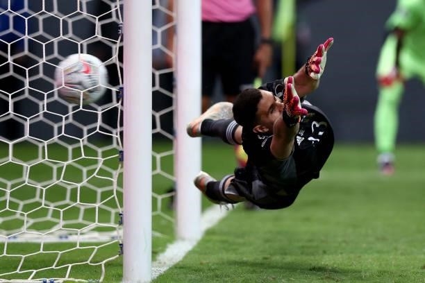 Emiliano Martinez Goalkeeper of Argentina dives during a penalty shootout in the Conmebol Copa America Brazil 2021 semi-final between Argentina and...