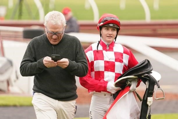 Jamie Kah talks with Mick Price after riding National Choice in the @2unitspodcast Handicap at Ladbrokes Park Hillside Racecourse on July 07, 2021 in...
