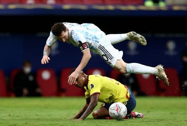 Lionel Messi of Argentina competes for the ball with Wilmar Barrios of Colombia during the Conmebol Copa America Brazil 2021 semi-final between...