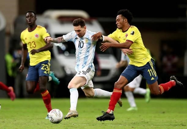 Lionel Messi of Argentina competes for the ball with Juan Cuadrado of Colombia during the Conmebol Copa America Brazil 2021 semi-final between...