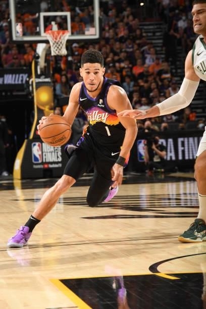 Devin Booker of the Phoenix Suns dribbles the ball during Game One of the 2021 NBA Finals on July 6, 2021 at Phoenix Suns Arena in Phoenix, Arizona....