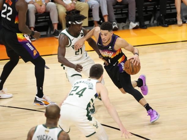 Jrue Holiday of the Milwaukee Bucks plays defense on Devin Booker of the Phoenix Suns during Game One of the 2021 NBA Finals on July 6, 2021 at...