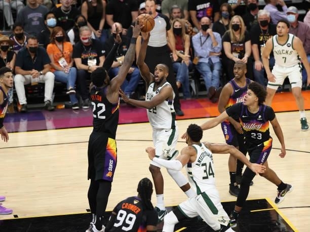 Deandre Ayton of the Phoenix Suns plays defense on Khris Middleton of the Milwaukee Bucks during Game One of the 2021 NBA Finals on July 6, 2021 at...