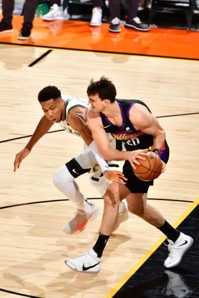 Giannis Antetokounmpo of the Milwaukee Bucks plays defense on Dario Saric of the Phoenix Suns during Game One of the 2021 NBA Finals on July 6, 2021...