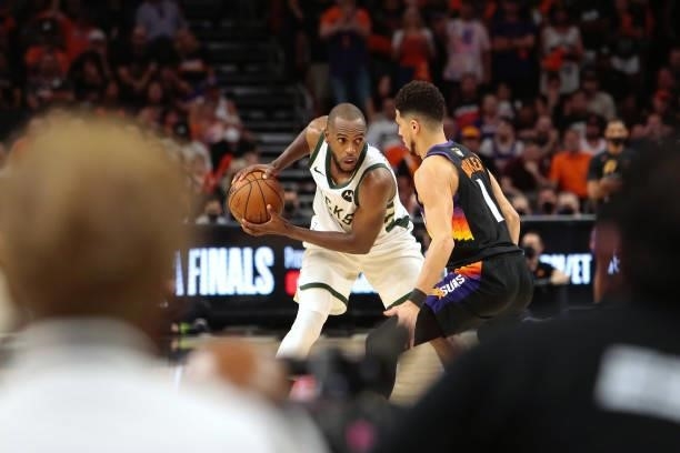 Khris Middleton of the Milwaukee Bucks looks to drive against Devin Booker of the Phoenix Suns during Game One of the 2021 NBA Finals on July 6, 2021...