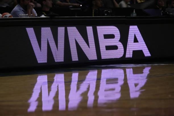 Sign appears on the court during the game between the Los Angeles Sparks and the Seattle Storm on July 7, 2021 at the Angel of the Winds Arena, in...