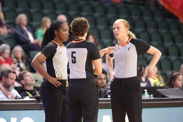 Referees, Karleena Tobin, Ashley Gloss and Tiara Cruse talk during the game between the Los Angeles Sparks and the Seattle Storm on July 7, 2021 at...