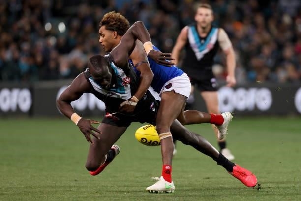 Kysaiah Pickett of the Demons tackles Aliir Aliir of the Power during the 2021 AFL Round 17 match between the Port Adelaide Power and the Melbourne...