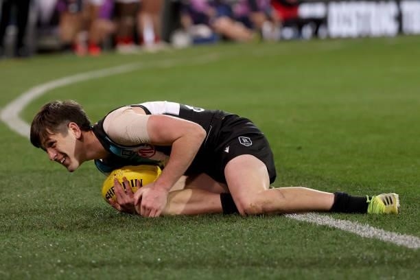Zak Butters of the Power injures his knee during the 2021 AFL Round 17 match between the Port Adelaide Power and the Melbourne Demons at Adelaide...