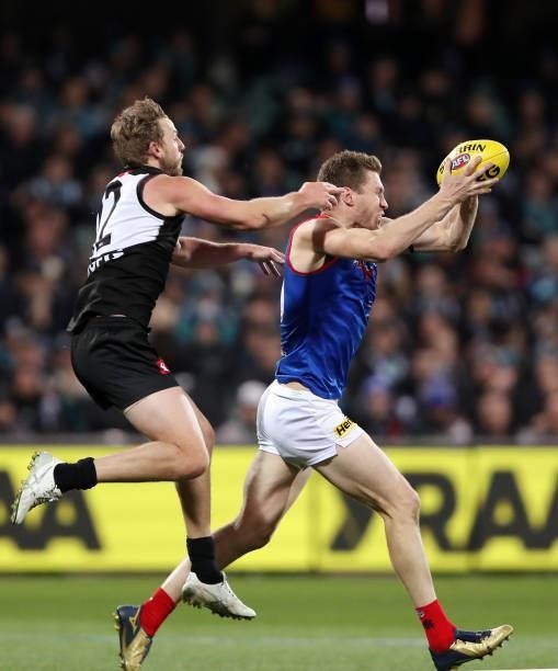 Tom McDonald of the Demons marks the ball in front of Trent McKenzie of the Power during the 2021 AFL Round 17 match between the Port Adelaide Power...