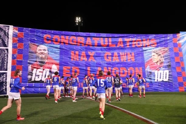Melbourne run through the banner during the 2021 AFL Round 17 match between the Port Adelaide Power and the Melbourne Demons at Adelaide Oval on July...