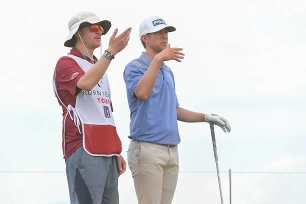Chandler Eaton talks with his caddie on the fourth tee box during the first round of the Korn Ferry Tours TPC Colorado Championship at Heron Lakes on...
