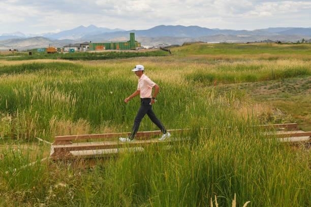 Garett Reband walks across a bridge on the 15th hole during the first round of the Korn Ferry Tours TPC Colorado Championship at Heron Lakes on July...