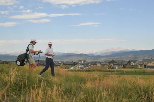 Cameron Young and his caddie walk off the fourth tee box during the first round of the Korn Ferry Tours TPC Colorado Championship at Heron Lakes on...