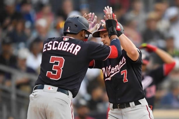 Trea Turner of the Washington Nationals is congratulated by Alcides Escobar after hitting a two-run home run during the fourth inning of a baseball...