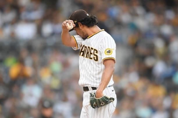 Yu Darvish of the San Diego Padres walks back to the mound after giving up a run during the third inning of a baseball game against Washington...