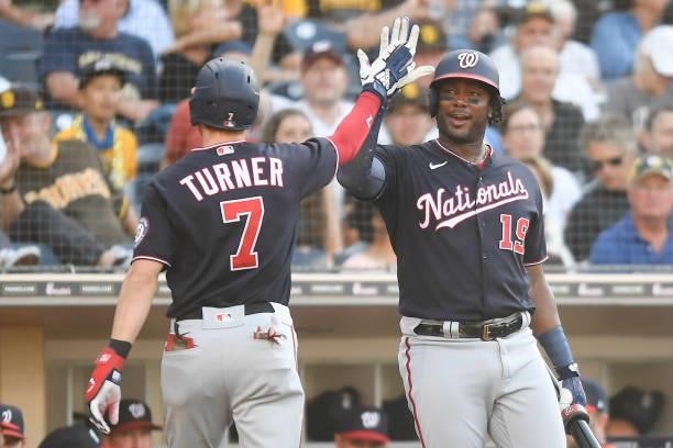 Trea Turner of the Washington Nationals is congratulated by Josh Bell after hitting a solo home run during the first inning of a baseball game...