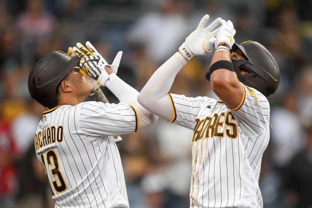 Fernando Tatis Jr. #23 of the San Diego Padres, right, is congratulated by teammate Manny Machado after hitting a solo home run during the fourth...