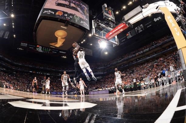 Deandre Ayton of the Phoenix Suns drives to the basket as Jrue Holiday of the Milwaukee Bucks plays defense during Game Two of the 2021 NBA Finals on...
