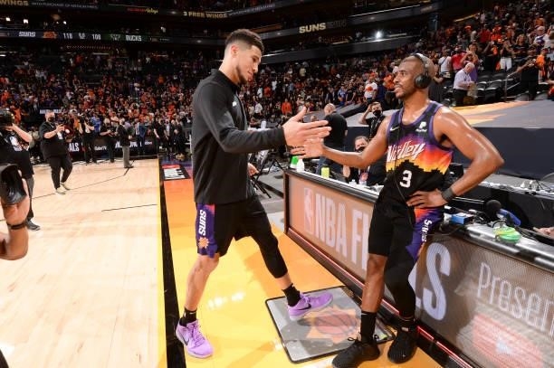 Devin Booker of the Phoenix Suns high fives Chris Paul of the Phoenix Suns after the game against the Milwaukee Bucks during Game Two of the 2021 NBA...