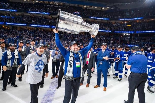 Massage Therapist Christian Rivas of the Tampa Bay Lightning hoists the Stanley Cup overhead after the Tampa Bay Lightning defeated the Montreal...