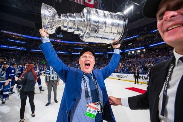 Mathieu Darche, Director Of Hockey Operations for the Tampa Bay Lightning hands the Stanley Cup to CEO Steve Griggs after the Tampa Bay Lightning...