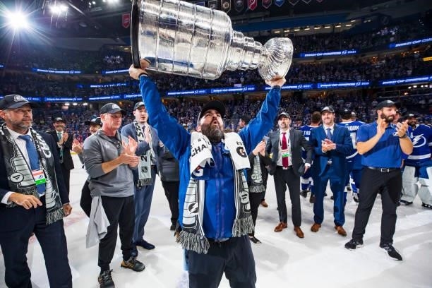 Assistant Equipment Manager Jason Berger of the Tampa Bay Lightning hoists the Stanley Cup overhead after the Tampa Bay Lightning defeated the...