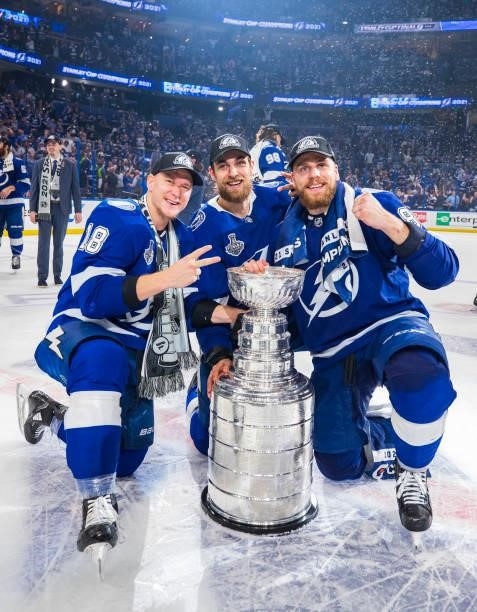 Ondrej Palat, Jan Rutta, and Erik Cernak of the Tampa Bay Lightning celebrates with the Stanley Cup after defeating the Montreal Canadiens in Game...